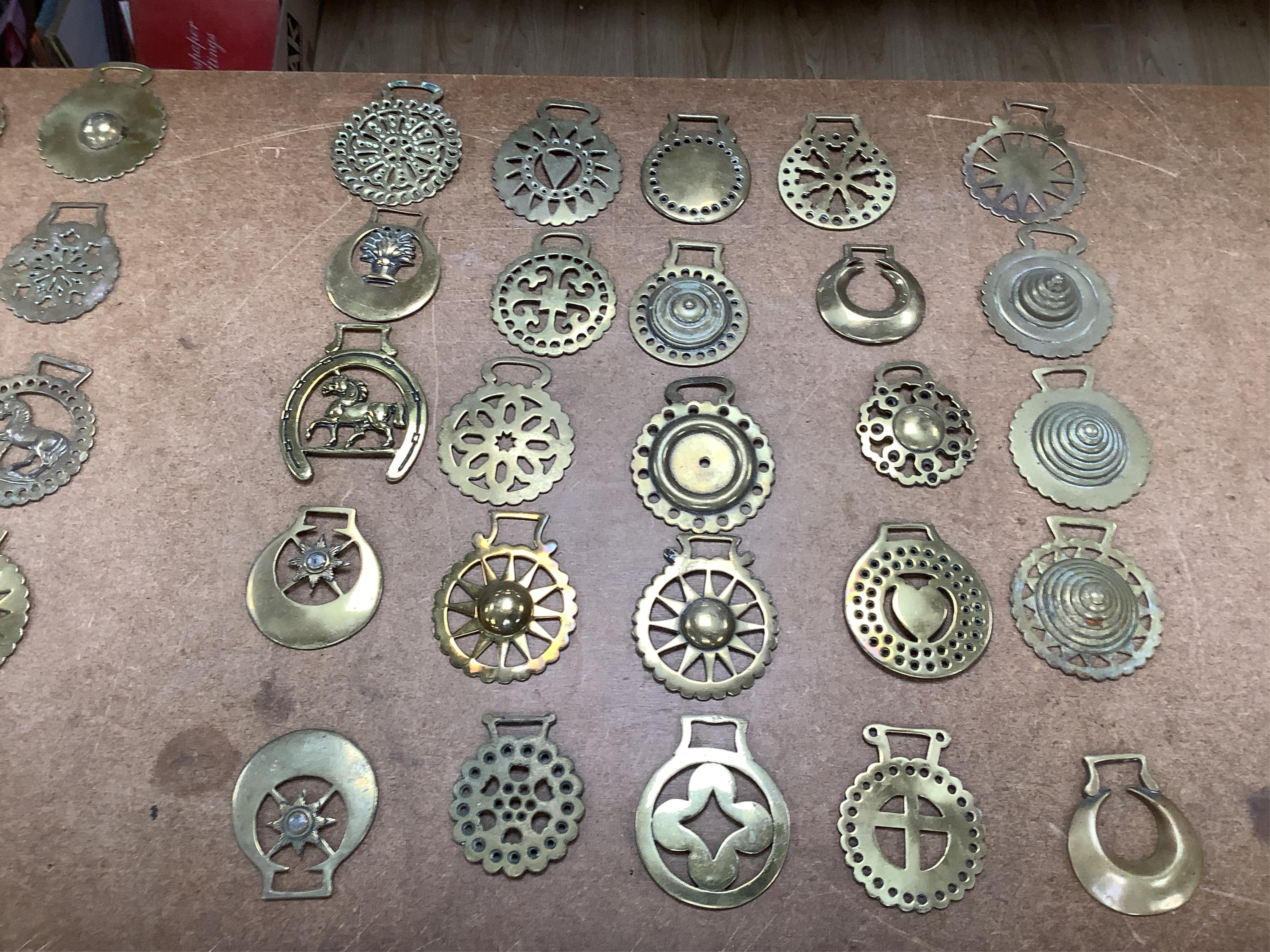 A collection of various horse brasses